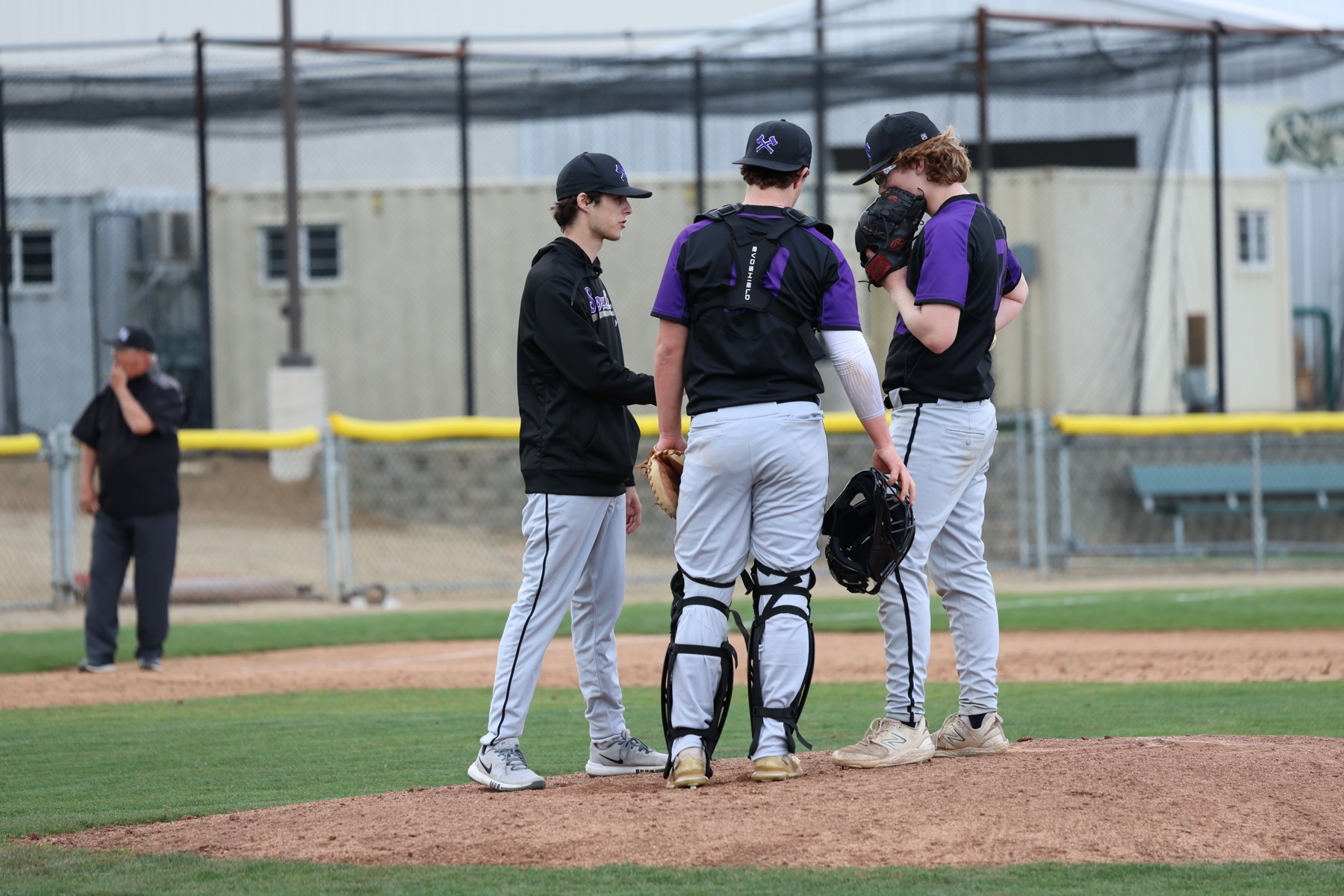 Austin Lachapelle talking with pitchers on the mound during a game